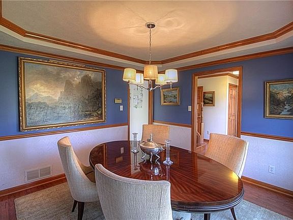 The dining room is beautifully appointed with tray ceiling, wood moldings and chair rail for that classic design!