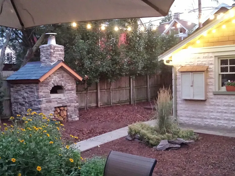 Low maintenance back yard with brick wood-fired pizza oven!