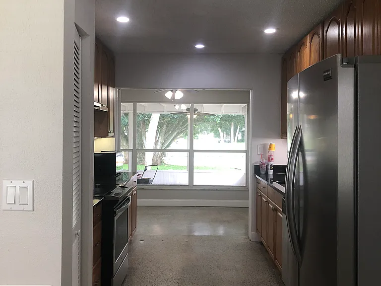 Galley kitchen from dining to Florida room to patio