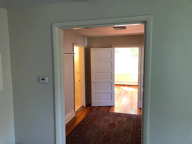Foyer showing entrance to bathroom to the left and master bedroom entrance.
