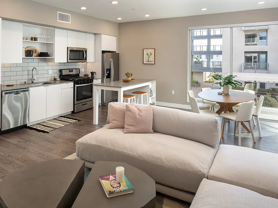 Open concept kitchen and living area with hard surface flooring