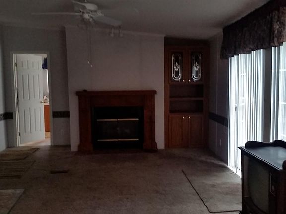 Family room with gas fireplace - Glass sliding doors to deck - Door on left goes to laundry room and side door to deck