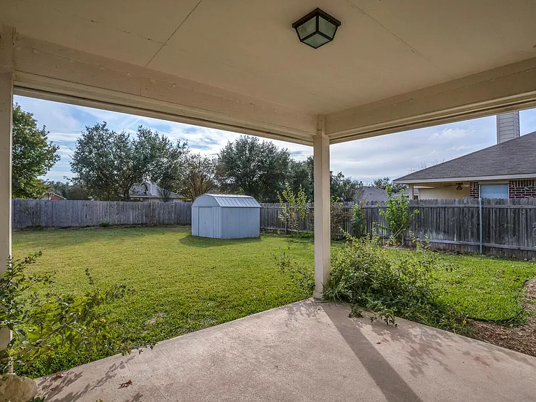 Covered backyard patio.