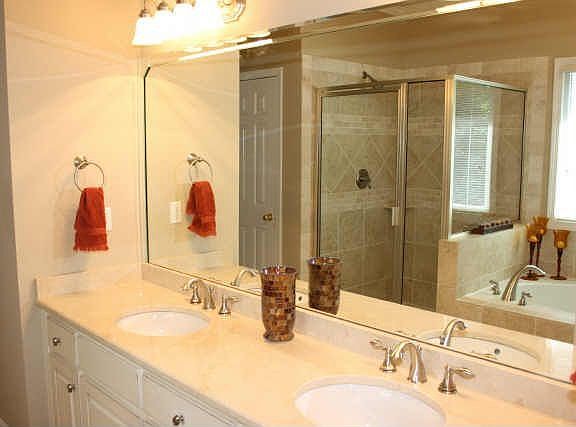 newly tiled shower with new glass door--all the brass is gone!