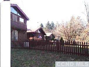 Two private living spaces with middle common living area; legal two family residence or one family.