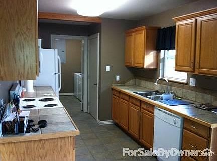 Kitchen and Laundry Room
						:
						Tile throughout the kitchen, dining room, & laundry room. Appliances remain.