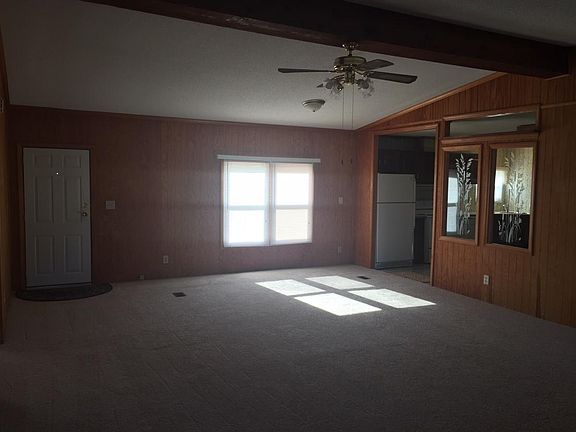 Large Living Room with Decorative Windows To Kitchen