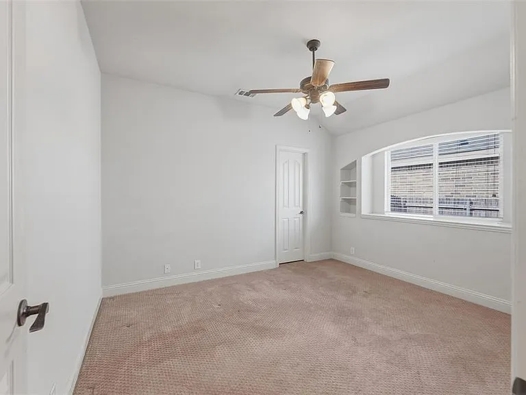3rd bedroom downstairs with carpet, vaulted ceiling, ceiling fan