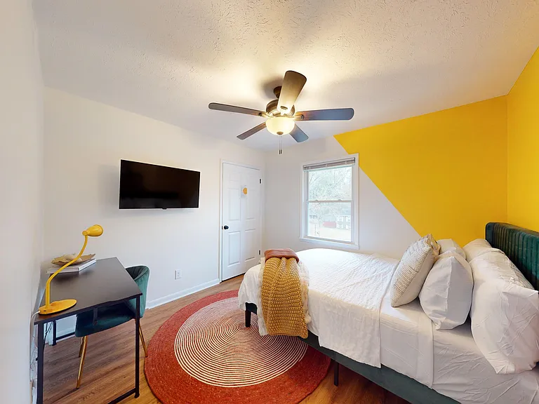Queen Bedroom with a Desk and a TV