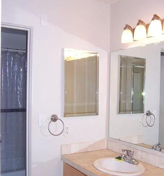 Large tiled sink area with tons of closet space, separate from tub/shower/toilet.
