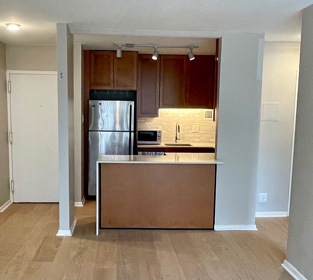 Fully renovated kitchen; new countertops and cabinets; stainless steel appliances; glass tile backsplash.