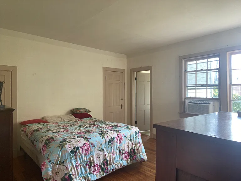Bedroom looking at rear windows and bathroom door