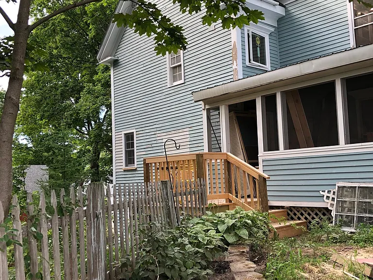 View of private deck and entry to the unit. Image taken while under renovation.