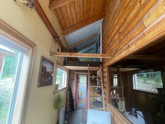 Sunroom with loft sleeping area above. Small guest sleeping area up ladder.