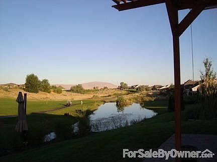 view from back patio : view of rattlesnake mountain and pond with fountains and waterfalls