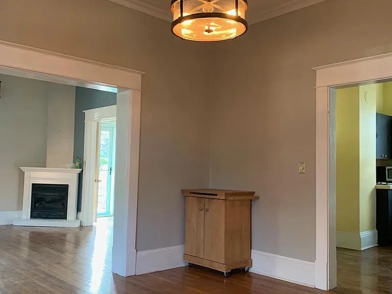 Dining room looking toward front of the house. Living room is on the left side of the photo and the kitchen is on the right side of the photo.