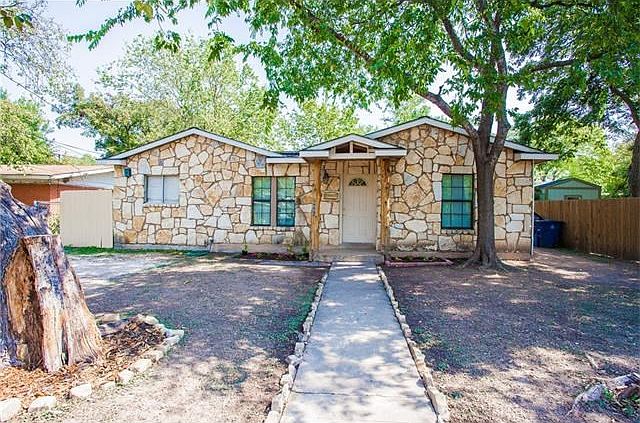Custom natural stone work on front of house with driftwood pillars (new grass coming soon!)