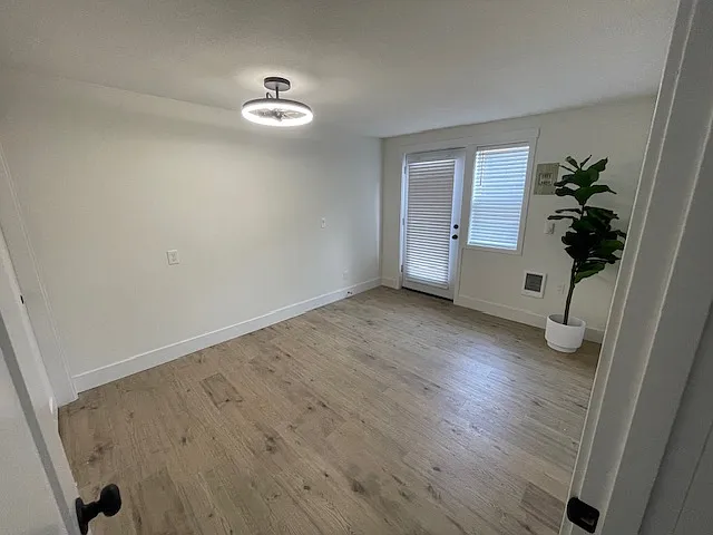Blinds installed on all windows in the bedroom, also the large row of windows in the living room. Modern light/fan fixture with remote control for the fan feature. New floors throughout.