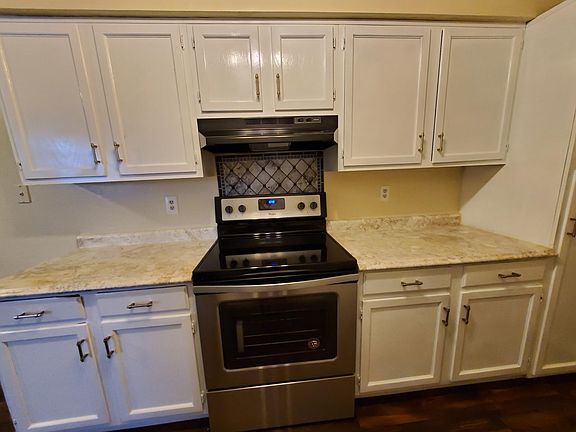 Stove and beautiful counter and cabinets