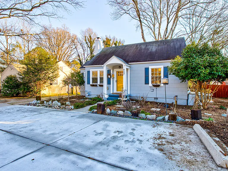 Front Exterior Idlewood House at 907 W Wendover Ave, Greensboro NC Historic 1948 bungalow curb appeal with mature landscaping and seasonal garden in the Idlewood neighborhood, perfect for renters who enjoy walkable Greensboro living.