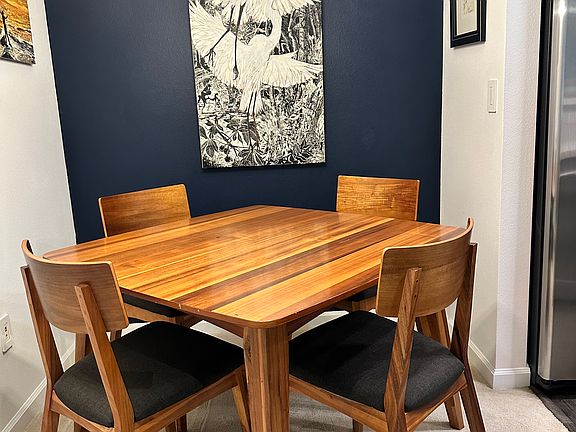 Dining area with original artwork on wall