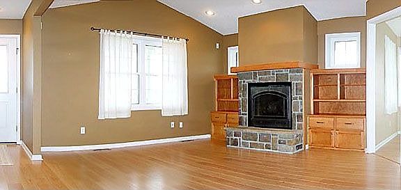 Great Room with Hardwood Floors, Custom Surround and Gas Fireplace