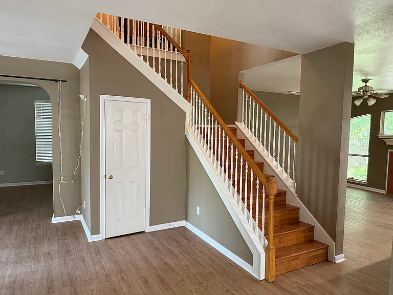 View of staircase from dining room - a nice statement next to the foyer of the home, everything feels very spacious and open.