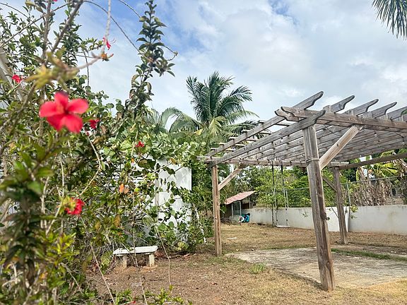 Backyard area with wood pergola. Completely fenced in yard safe area for children to play and pets to roam free. Built in chicken __ coop!