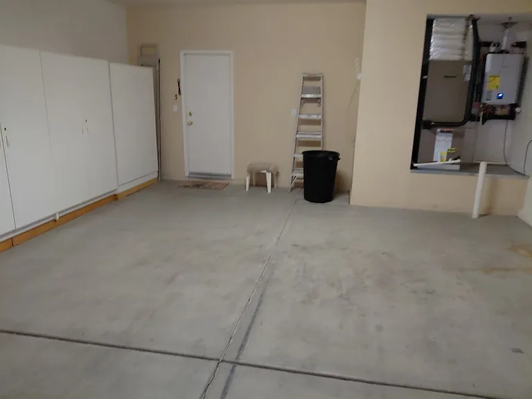 New tankless water heater in oversized garage with loads of storage