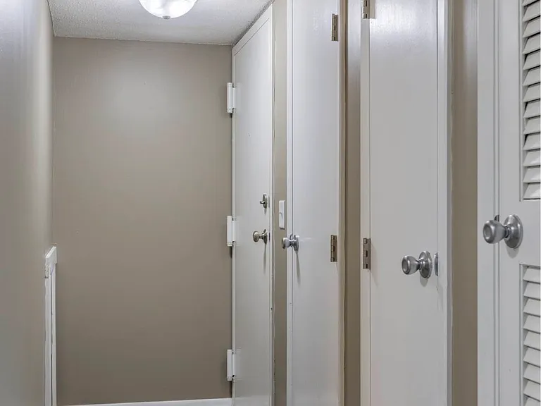 Hallway with storage closets in a unit at Ashland Park Apartments.