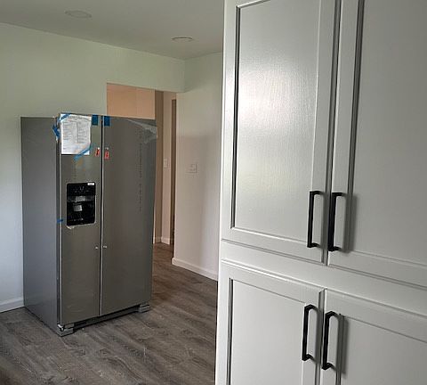 Kitchen with additional cabinets in Washer/dryer area