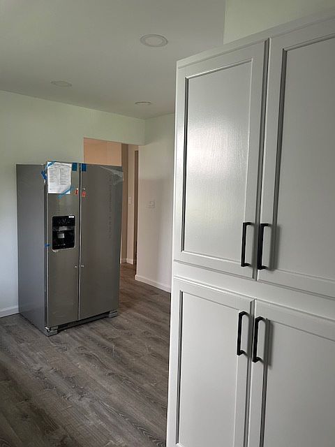 Kitchen with additional cabinets in Washer/dryer area