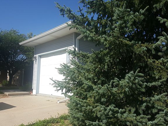 Garage and large evergreen.