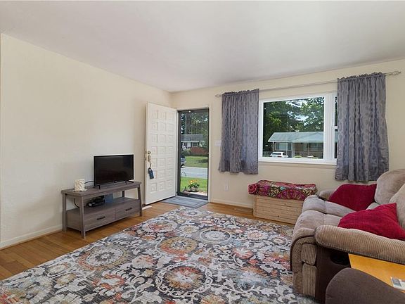 Living room with great lighting from large window and hardwood floors