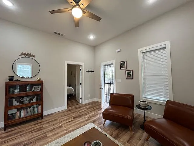Enter into the living spacious living space with 10 foot ceilings, ceiling fan, wood laminate flooring, large windows for ample natural light.