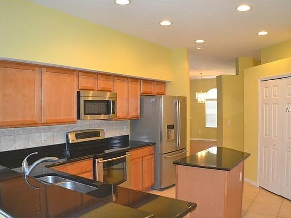 Updated KITCHEN with GRANITE Counters, BREAKFAST BAR, newer SS APPLIANCES, pull out drawers on lower