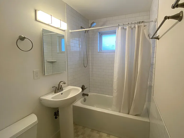 Our newly remodeled bathroom has subway tiling and frosted windows for privacy and natural light!