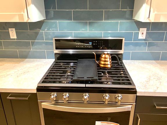 Kitchenaid ducted vent hood . Whirlpool WIFI gas range with griddle burner