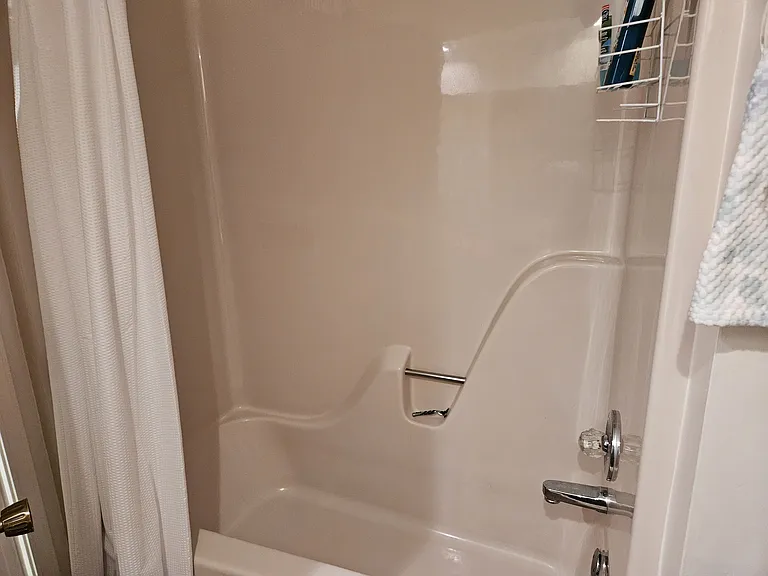 Shower-tub combination in bathroom located between the two bedrooms. Toilet with attached toilet bidet.