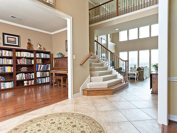 Entry leads to living room and opens to two-story den.