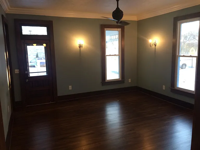 family room, looking at the front door, the original turn of the century door. This picture highlights the beautiful 2.25" solid white oak flooring