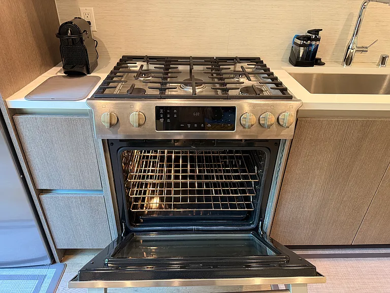 High-end Bosch appliances, includes this 5-burner gas range for gourmet cooking and oven with multiple shelves and warming drawer.