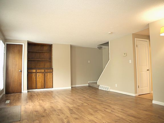 Spacious Family Room (wood door is a closet, stairs lead to upper level, white door is to basement)
