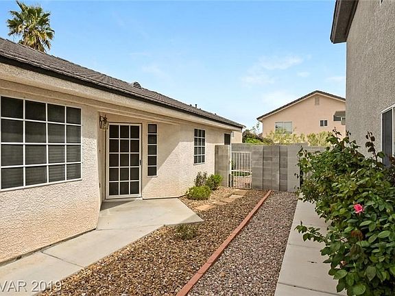 Nice sidewalk and side entry door and side gate to backyard