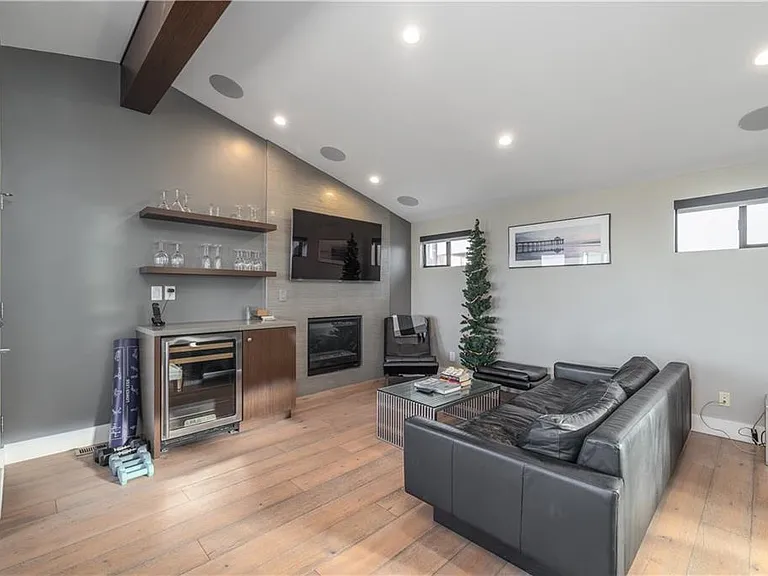 Living room has vaulted ceilings and gas fireplace. Surround sound system.