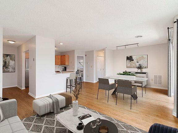 Renovated Package I living and dining room with hard surface flooring