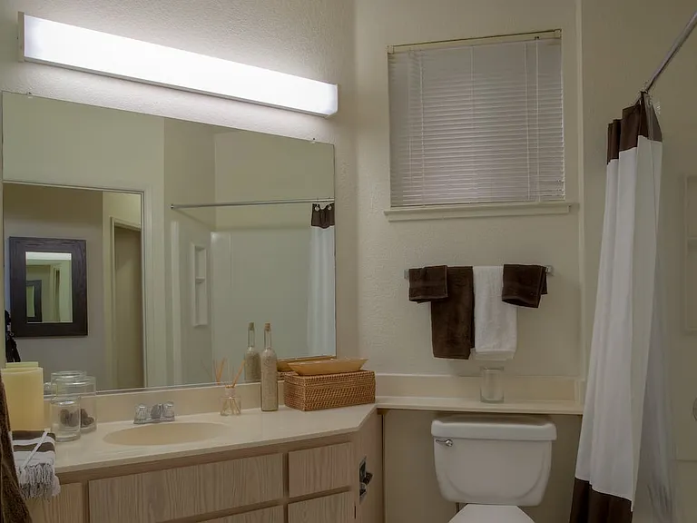 Classic Package I bath with light oak cabinetry, white laminate countertops, and hard surface flooring