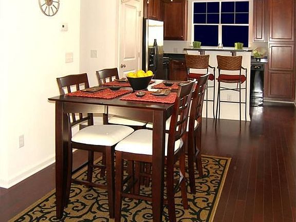 Dining area off the kitchen. Gorgeous hardwood flooring throughout condo