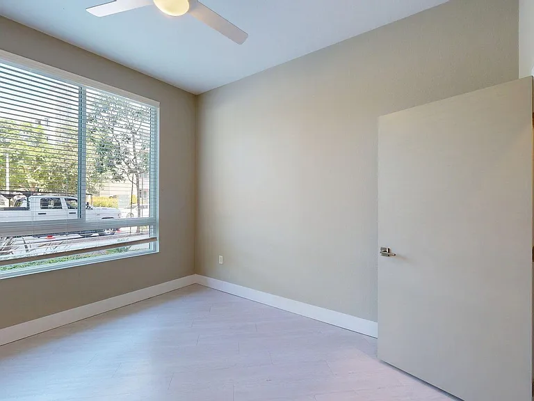 Spacious apartment Bedroom with Wood-Style Flooring.