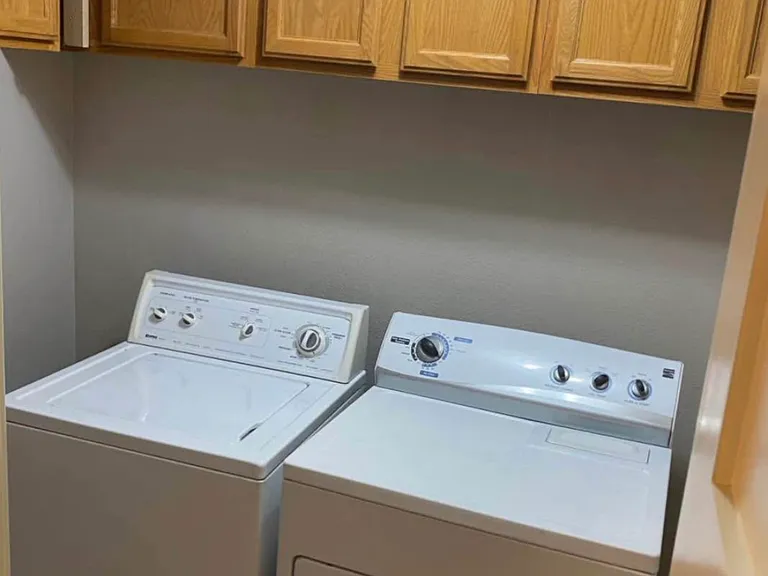 Full sized washer and dryer. Cabinets.
